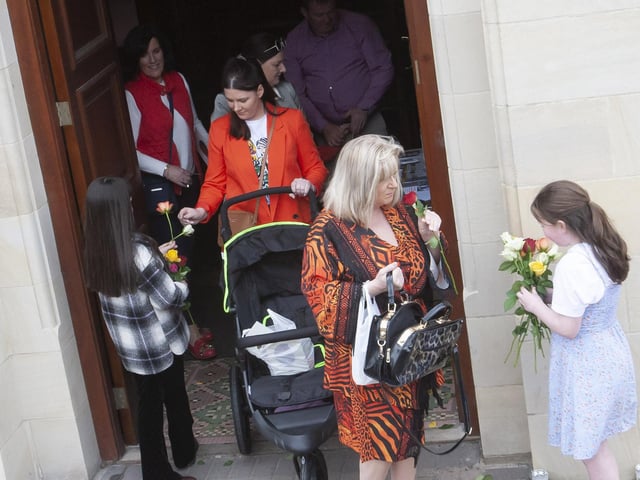 Children handing out flowers at the end of Sunday’s Sister Clare Crockett Retreat in the Long Tower Church.