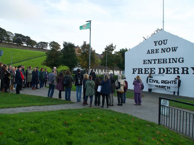 Crowds attend memorial at Free Derry Corner.