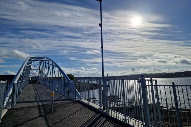 The sun hovering over Derry's new pedestrian bridge at Pennyburn this morning. The new bridge and new riverside stretch of path, which links the wider Derry and Donegal greenway network, opened this week and is already proving very popular with walkers, runners and cyclists.