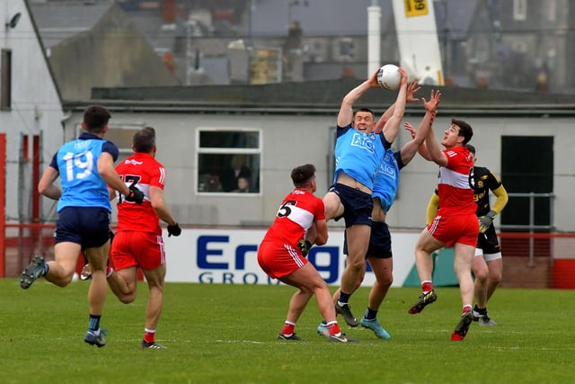Derry’s Conor Doherty gets a grip on Con O’Callaghan of Dublin. Photo: George Sweeney. DER2309GS – 43
