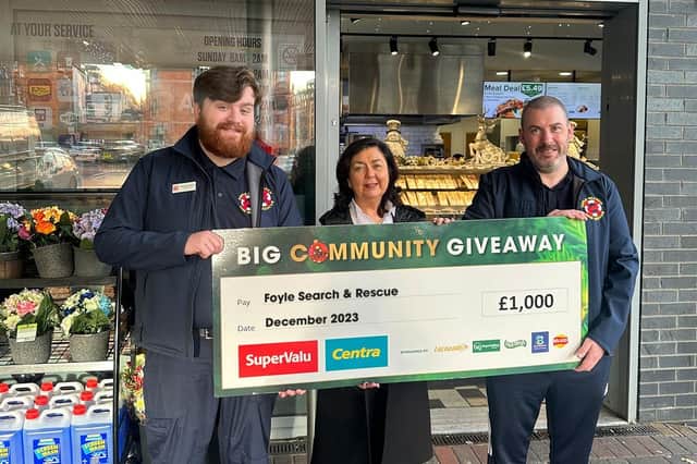 Foyle Search & Rescue volunteers Rossa Smallman (left) and Adrian McMenamin (right) visit Moran’s Centra Strand Road, where owner Donna Moran presents them with a donation of £1,000 as part of SuperValu and Centra’s £40K Big Community Giveaway.