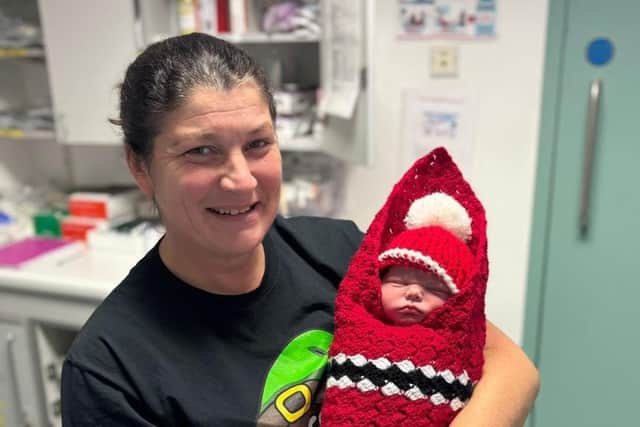 Baby Alfie pictured with one of the midwives on duty