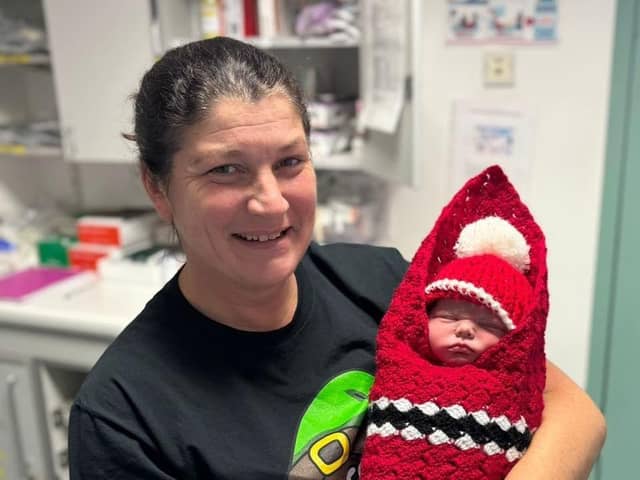 Baby Alfie pictured with one of the midwives on duty