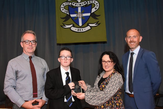 Year 8 Overall Commitment prizewinner 2022-2023, Tyler McCready 8A receiving his award from Mrs. C. McLaughlin, Vice Principal. On left it Mr T McGonigle, Senior Teacher, and on right, Mr D Marlow, Year Head.