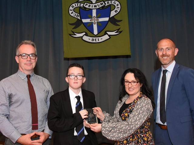 Year 8 Overall Commitment prizewinner 2022-2023, Tyler McCready 8A receiving his award from Mrs. C. McLaughlin, Vice Principal. On left it Mr T McGonigle, Senior Teacher, and on right, Mr D Marlow, Year Head.