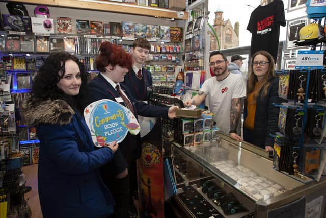 Pete from the Angry Cherry, Foyle Street, Derry pictured making a donation to the Oakgrove College Book Pledge on Friday.