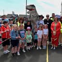 Pupils and members of the school’s PTA pictured with Mayor Patricia Logue, and the visiting Tyrannosaurus, at the Long Tower Primary School Family Fun day on Friday afternoon. Photo: George Sweeney. DER2322GS – 113