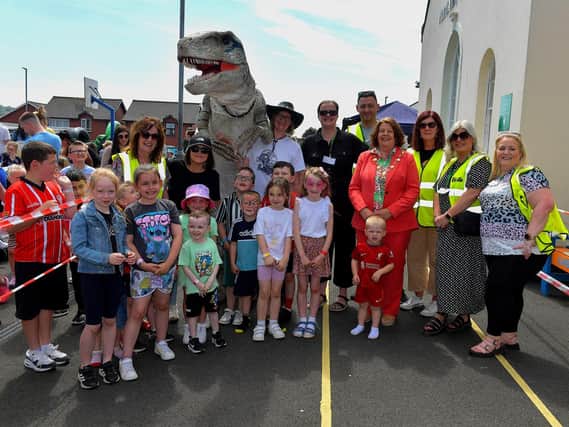 Pupils and members of the school’s PTA pictured with Mayor Patricia Logue, and the visiting Tyrannosaurus, at the Long Tower Primary School Family Fun day on Friday afternoon. Photo: George Sweeney. DER2322GS – 113