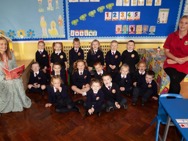 Mrs. Caitriona McCartney pictured with her P1 class at Holy Child PS this week. Included on right is Ms. Tanya Griffin, Classroom Assistant. (Photos: Jim McCafferty Photography)