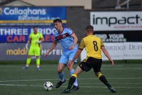 Institute‘s Liam Mullan is challenged by Aston McDermott of Knockbreda.  Photograph: George Sweeney. DER2331GS – 92 