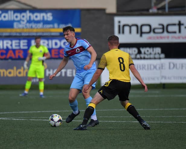 Institute‘s Liam Mullan is challenged by Aston McDermott of Knockbreda.  Photograph: George Sweeney. DER2331GS – 92 
