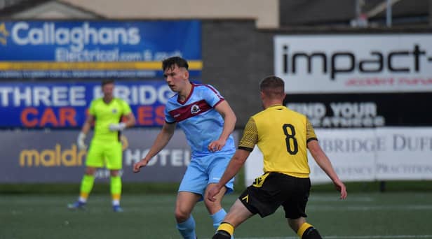 Institute‘s Liam Mullan is challenged by Aston McDermott of Knockbreda.  Photograph: George Sweeney. DER2331GS – 92 