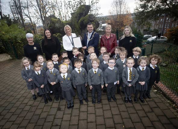 The Mayor of Derry City and Strabane District Council, Ruairi McHugh pictured with the P1 class at Model Primary School last week. Included at back, from left are Ms. Corinna Wilson, LSA, Ms. Shauna Marie Gallen, teacher, Mrs. Julie McCarter, Principal, Ms. Daisy Mules, chair, board of governors and Ms. Grace Canning, LSA. (Photos: Jim McCafferty Photography)