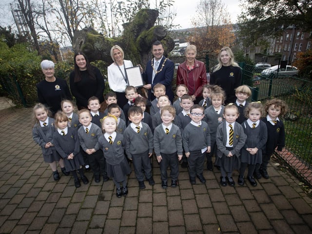 The Mayor of Derry City and Strabane District Council, Ruairi McHugh pictured with the P1 class at Model Primary School last week. Included at back, from left are Ms. Corinna Wilson, LSA, Ms. Shauna Marie Gallen, teacher, Mrs. Julie McCarter, Principal, Ms. Daisy Mules, chair, board of governors and Ms. Grace Canning, LSA. (Photos: Jim McCafferty Photography)