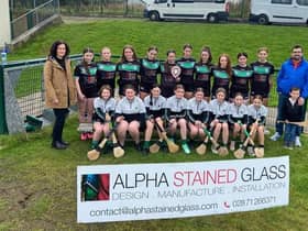 Former camogie player Teresa Coyle, together with Joe Coyle, presents Na Magha’s Under 16 camogie team with a new training kit in recognition of their recent Shield success.