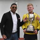Sports Hub representatives present Fox Lodge captain Aaron Heywood, with the Senior Cup after their win last year.