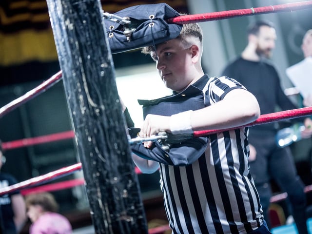 The referee checking the ring.