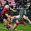 John McManus of Down grapples with Derry’s  Eamon Cassidy. Photo: George Sweeney