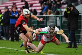 John McManus of Down grapples with Derry’s  Eamon Cassidy. Photo: George Sweeney