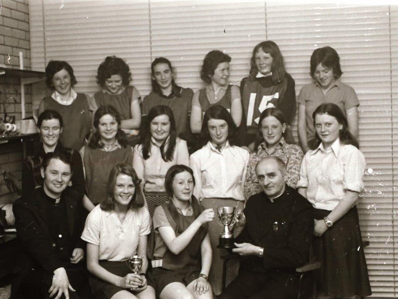 A young Fr Paddy O'Kane and Rev D. Mullan from St Eugene's Cathedral presenting trophies during the St Eugene's Youth Association netball and football competitions final held at Brooke Park. Fr Paddy organised the event.
