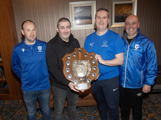 Peter Hutton, former Derry City manager and captain, special guest, presents the Crampsey Family Shield to Oxford Senior Men's coach, John Walker. Included are coaches Shaun Whoriskey and Sean Doherty.