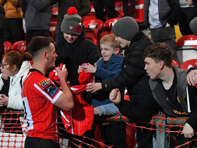 Danny Mullen gives a Derry City shirt to a delighted young fan.  Photograph: George Sweeney