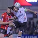 Derry’s Shane McEleney rises to challenge Patrick Hoban of Dundalk last season. Photograph by Ciaran Culligan