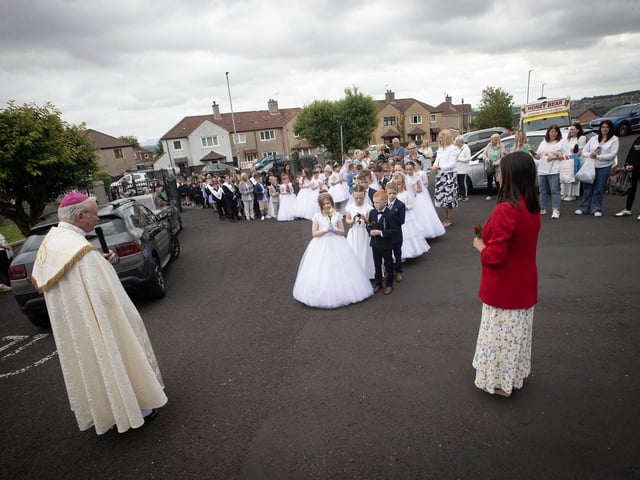The Bishop addresses the pupils from Holy Child PS as they enter the grounds of St. Mary's Church during the school's Annual May Procession on Thursday. On right is Mrs. Pat Concannon, Principal. (Photos: Jim McCafferty Photography)