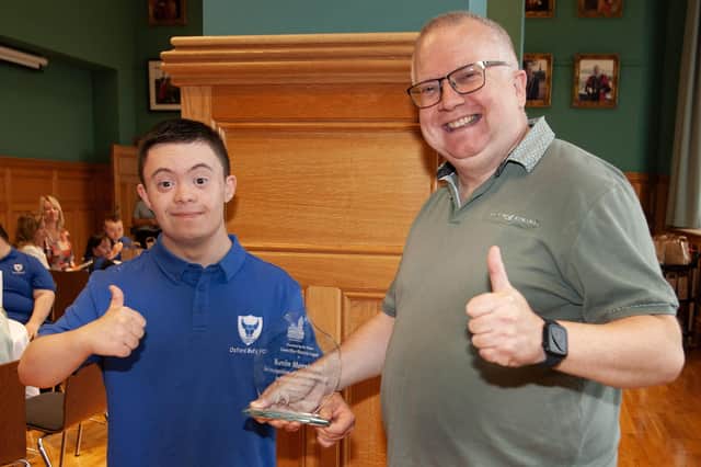 Kevin Morrison shows off his award with son Adam at the Guildhall on Wednesday evening.