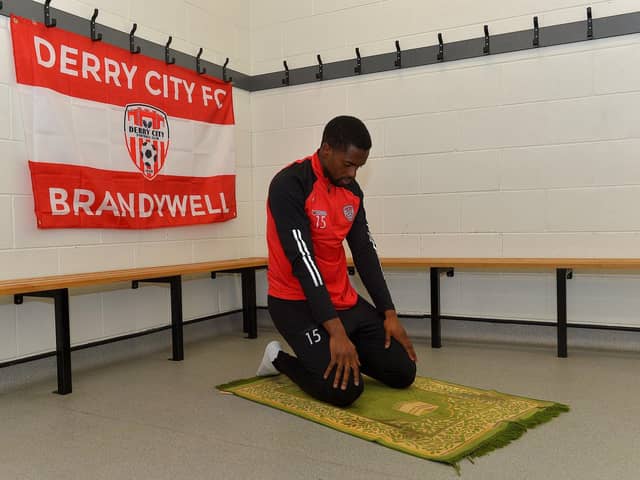 Derry City midfielder Sadou Diallo prays on his prayer rug at the Ryan McBride Brandywell Stadium. Photo: George Sweeney. DER2308GS – 18