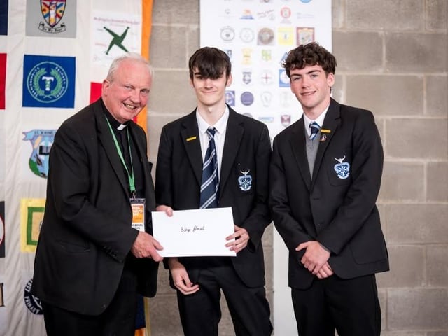 St Columb's College pupils making a presentation to Bishop Donal McKeown.