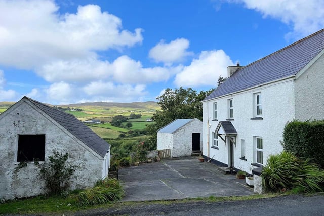 This beautifully maintained and modernised 2-storey, 3 bedroom farmhouse stands on a one acre site with Outbuildings and Sheds at Tullymore halfway between Malin Village and Malin Head only 5 minutes from Five Fingers Strand . The house which is part of an overall farm of 33 acres is being sold as a separate unit and is in excellent condition having been modernised yet retains many original features. The property, built around 80 years ago, has Bangor blue slates, pebble dash render, three spacious bedrooms, dual central heating, modern kitchen and spacious living room.
