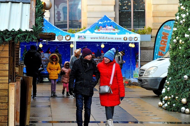 People visiting the Christmas Market in Guildhall Square on Friday afternoon. Photo: George Sweeney. DER2250GS – 62