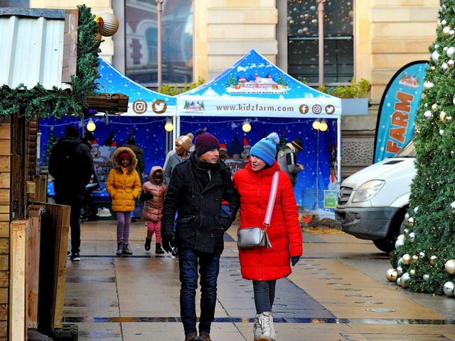 People visiting the Christmas Market in Guildhall Square on Friday afternoon. Photo: George Sweeney. DER2250GS – 62