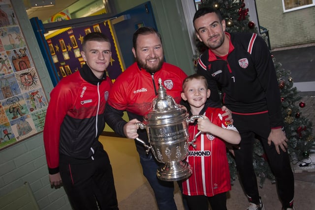 Greenhaw PS teacher Mr. Chrstopher Martin and his son Conor pictured with the FAI Cup on Monday last. Included are City players Caoimhin Porter and Michael Duffy.