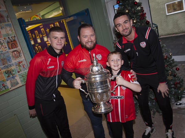 Greenhaw PS teacher Mr. Chrstopher Martin and his son Conor pictured with the FAI Cup on Monday last. Included are City players Caoimhin Porter and Michael Duffy.