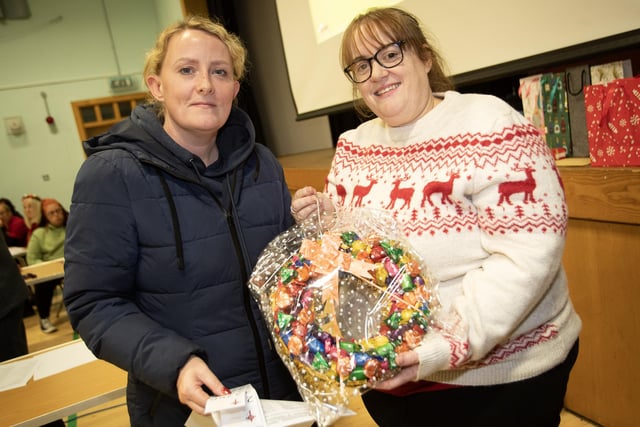 Patricia Quigley picks up her prize from Lisa Grant at St. Joseph's Boys School Annual Christmas Rickety Wheel on Thursday night at the school. (Photos: Jim McCafferty Photography)