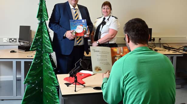 Imprisoned dads at Maghaberry have made personal recordings of the classic Christmas verse ‘The Night Before Christmas’ as part of a festive parcel for families of serving prisoners. The scheme, supported by NIACRO and Mothers Union is to assist prisoners’ families across Northern Ireland during the festive season. Pictured with one of the prisoner dads recording the story are Maghaberry Prison Governor David Savage, and Senior Officer Anita Payne. Picture: Michael Cooper