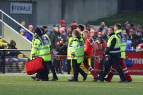 Derry City defender Mark Connolly is stretchered off after sustaining an injury in the first half against Dundalk at Brandywell. Photograph by Kevin Moore.