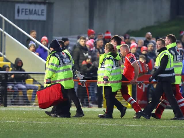 Derry City defender Mark Connolly is stretchered off after sustaining an injury in the first half against Dundalk at Brandywell. Photograph by Kevin Moore.