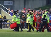 Derry City defender Mark Connolly is stretchered off after sustaining an injury in the first half against Dundalk at Brandywell. Photograph by Kevin Moore.