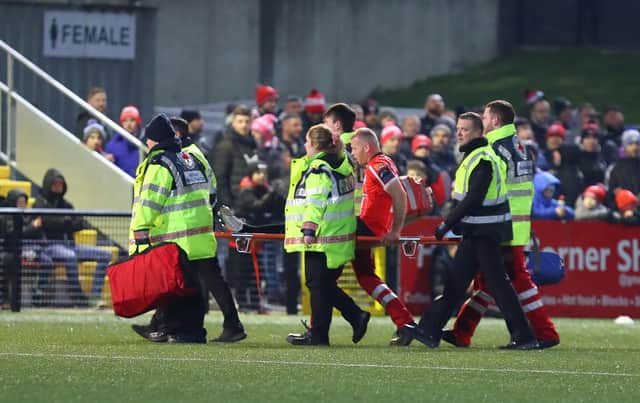Derry City defender Mark Connolly is stretchered off after sustaining an injury in the first half against Dundalk at Brandywell. Photograph by Kevin Moore.