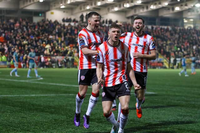 Ronan Boyce celebrates his opening goal with Ben Doherty and Will Patching at Brandywell on Friday.