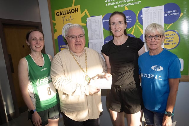 LADIES WINNERS. . . The Deputy Mayor, Darren Guy presenting the Galliagh Feile 5k winner Sarah Grant with her prize on Friday night. On left is Clare McDaid, 3rd, and on right, Itra Kelly, 2nd. (Photos: Jim McCafferty Photography)