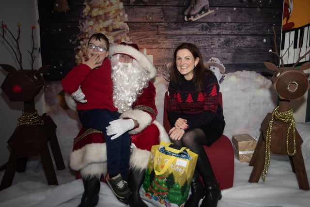 Elias and his mum telling Santa he is on the nice list.