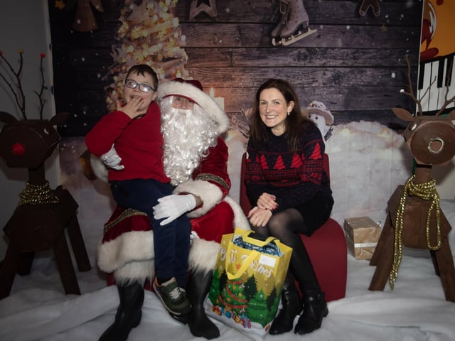 Elias and his mum telling Santa he is on the nice list.