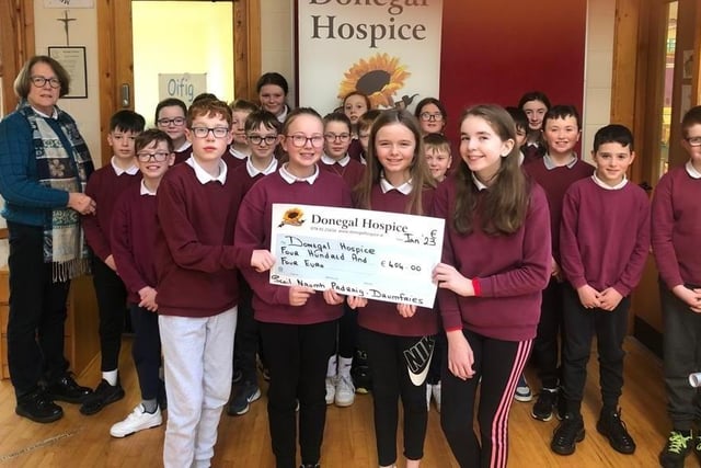 Pupils from Scoil Naomh Padraig, Drumfries, Inishowen,  presenting Deirdre Trearty of Donegal Hospice with a cheque for €404.00 raised at their Christmas draw.