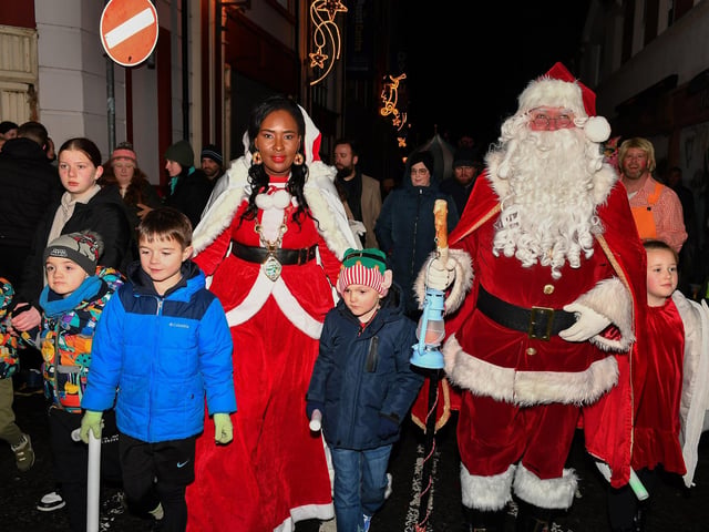 Mayor Lilian Seenoi Barr and Santa with children at the Derry Magical Christmas procession on Friday evening. Photo: George Sweeney