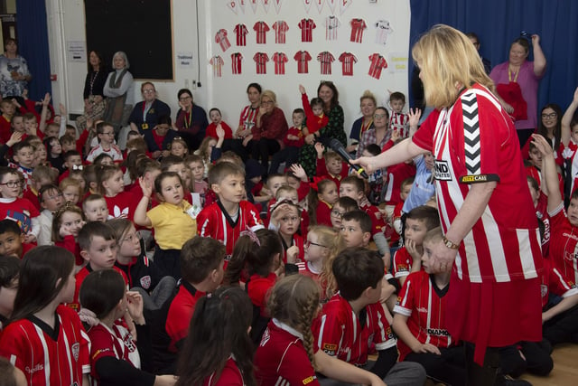 Steelstown P.S. Principal Mrs Siobhan Gillen performs compere duties for an eager audience during Tuesday's visit of Derry City players Shane and Patrick McEleney and Michael Duffy. (Photo: Jim McCafferty)
