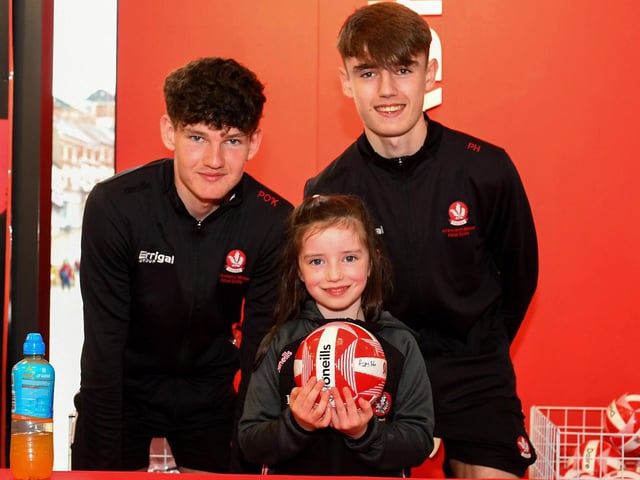 Hannah Bonnar pictured with Padraig O'Kane and Padraig Haran from Derry's All-Ireland Minor Champions team at O'Neill's Superstore last week. Photo: George Sweeney